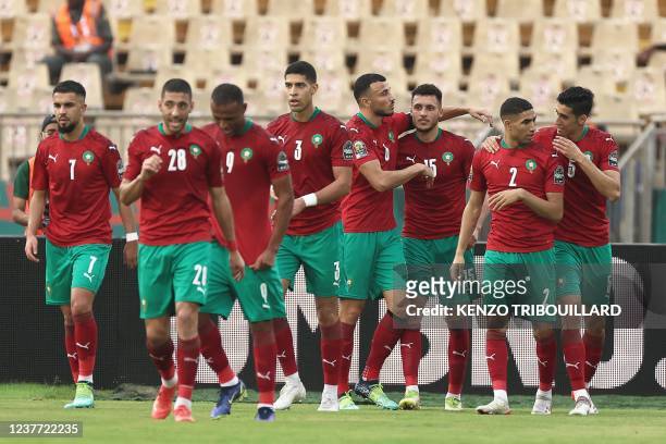 Morocco's midfielder Selim Amallah celebrates with teammates after scoring the opening goal during the Group C Africa Cup of Nations 2021 football...