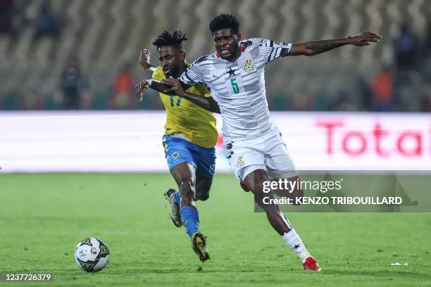 Gabon's midfielder Andre Biyogo Poko fights for the ball with Ghana's midfielder Thomas Partey during the Group C Africa Cup of Nations 2021 football...