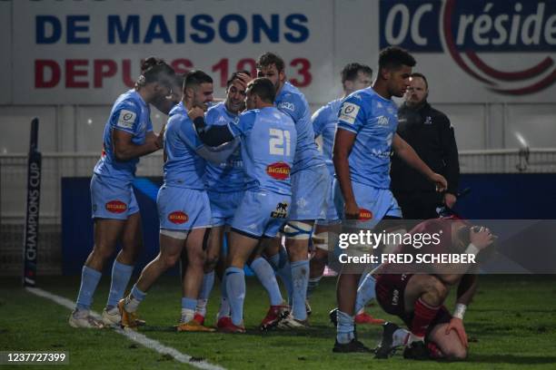 Castres' French full back Thomas Larregain celebrates with teammates after scoring a try during the European Champions Cup Round 3 Pool B rugby union...