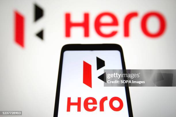 In this photo illustration, a Hero MotoCorp Limited logo is seen on a smartphone and a computer screen.