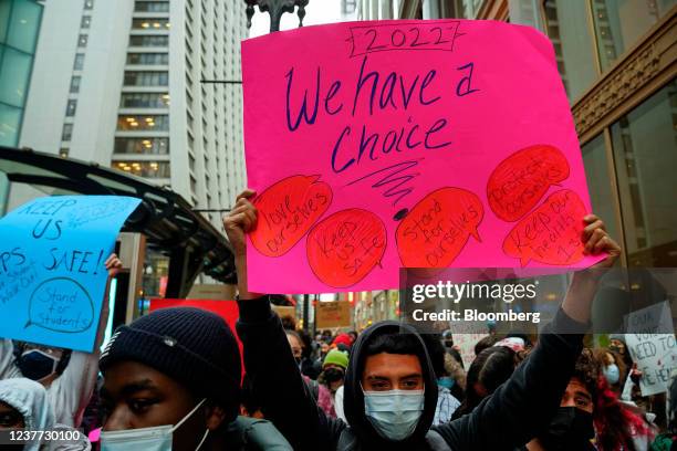 Demonstrators hold signs during a student walkout over Covid-19 safety measures at Chicago Public Schools in Chicago, Illinois, U.S., on Friday, Jan....