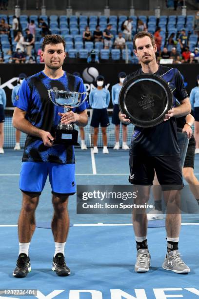 Andy Murray of Great Britain holds up the runners up trophy and Aslan Karatsev of Russia holds up the winners trophy after the Sydney Classic Tennis...