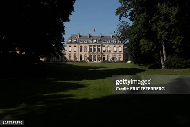 Picture taken in Paris on June 28, 2019 shows the southern facade of the Elysee palace and part of the garden of two hectares during the summer...