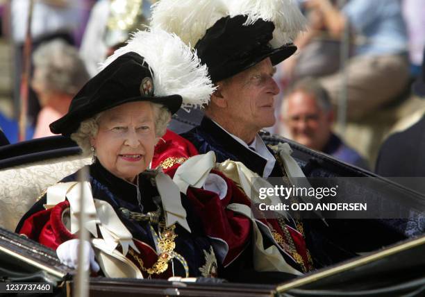 Queen Elizabeth II and the Duke of Edinburgh leave St. George's chapel at Windsor Castle ,14 June, 2004 after the order of Garter service . AFP PHOTO...