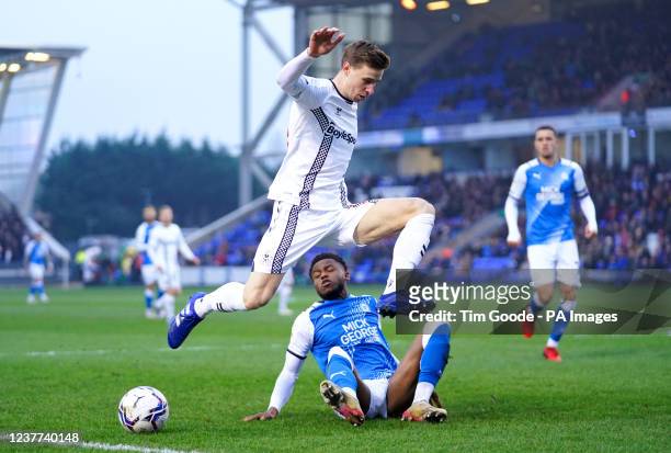 Coventry City's Ben Sheaf jumps over Peterborough United's Bali Mumba as they battle for the ball during the Sky Bet Championship match at the Weston...