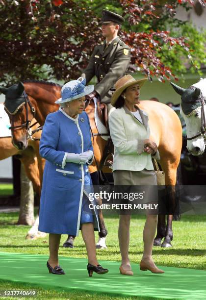 Britain's Queen Elizabeth II views horses and riders from the Irish Army Equitation school with Chryss O'Reilly, Chair of the board of the Irish...