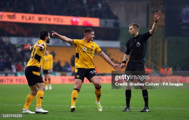 Wolverhampton Wanderers' Joao Moutinho and Leander Dendoncker appeal to referee Michael Salisbury for a penalty before it is awarded after a VAR...