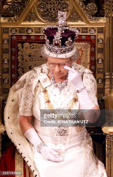 Britain's Queen Elizabeth II wipes her eye following her speech at the State Opening of Parliament 17 November 1999 in the House of Lords. The Queen...