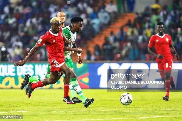 Sudan's midfielder Al Gazoli Hussein Nooh fights for the ball with Nigeria's defender Kenneth Omeruo during the Group D Africa Cup of Nations 2021...