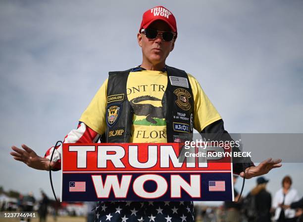 Donald Trump supporter Jonathan Riches holds a "Trump Won" sign before the first rally of the year by former US President Donald Trump, January 15,...