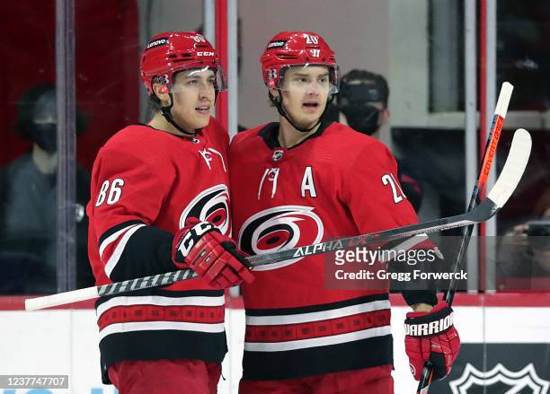 Sebastian Aho of the Carolina Hurricanes celebrates his first-period goal against the Vancouver Canucks with teammate Teuvo Teravainen during an NHL...