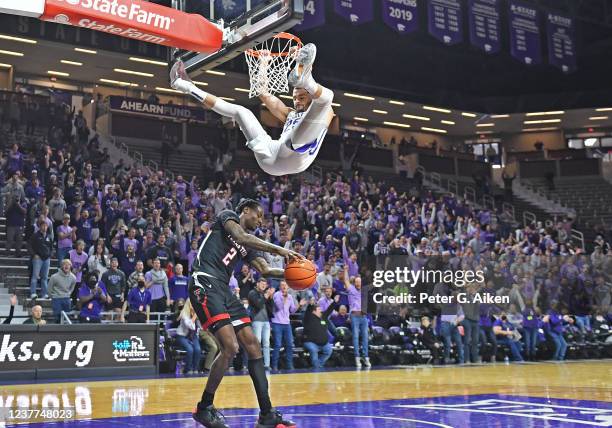 Ismael Massoud of the Kansas State Wildcats reacts after dunking against Davion Warren of the Texas Tech Red Raiders, during the second half at...