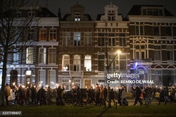 Participants of a torch protest walk in the center of Groningen, on January 15, 2022 as the activists want to show that people from Groningen no...