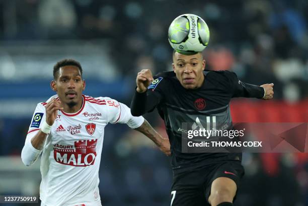 Paris Saint-Germain's French forward Kylian Mbappe and Brest's French defender Christophe Herelle fight for the ball during the French L1 football...