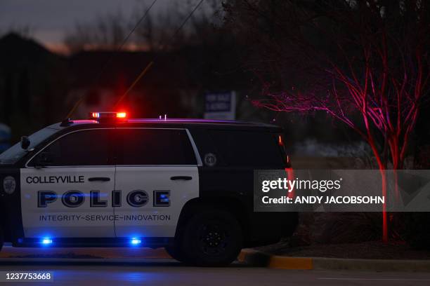 Police car is seen driving close to the Congregation Beth Israel Synagogue in Colleyville, Texas, some 25 miles west of Dallas, on January 15, 2022....