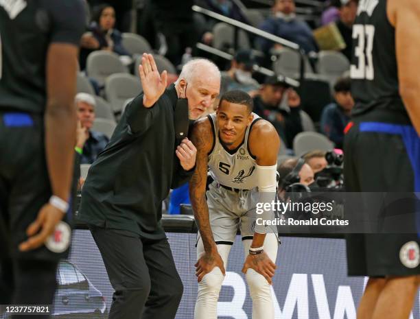 Dejounte Murray of the San Antonio Spurs listens to instruction from head coach Gregg Popovich during game against the Los Angeles Clippers in the...