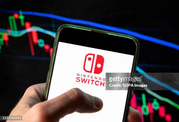In this photo illustration the Japanese multinational video gaming brand created and owned Nintendo, Nintendo Switch logo seen displayed on a...