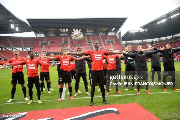 Rennes' French forward Serhou Guirassy and his teammates applaud supporters at the end of the French L1 football match between Stade Rennais Football...