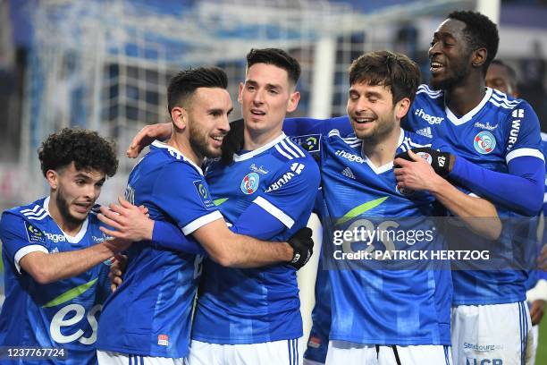 Strasbourgs French midfielder Adrien Thomasson celebrates with teammates after scoring a goal during the French L1 football match between Strasbourg...