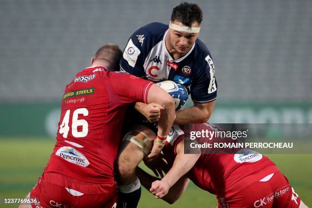 Bordeaux-Begles' French number 8 Alban Roussel is tackled by Scarlets' Welsh lock Morgan Jones during the European Champions Cup Round 3 Pool B rugby...