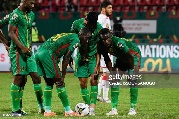 Mauritania's forward Pape Ibnou Ba speaks with Mauritania's defender Abdoulkader Thiam during the Group F Africa Cup of Nations 2021 football match...