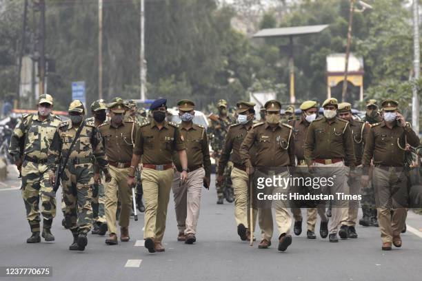 Noida Police along with Border Security Force personnel during a flag march in the view of the upcoming Assembly elections in Sector 8, on January...