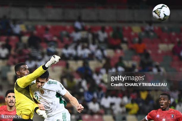 Equatorial Guinea's goalkeeper Jesus Owono makes a save from an attempt at goal from Algeria's defender Aissa Mandi during the Group E Africa Cup of...