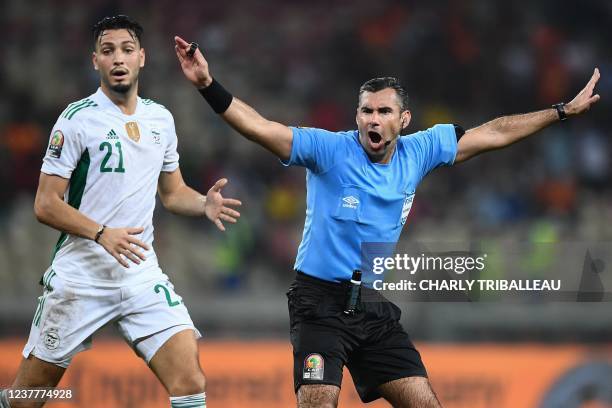 Algeria's defender Ramy Bensebaini reacts as Guatemalan referee Mario Escobar signals that there is no penalty during the Group E Africa Cup of...