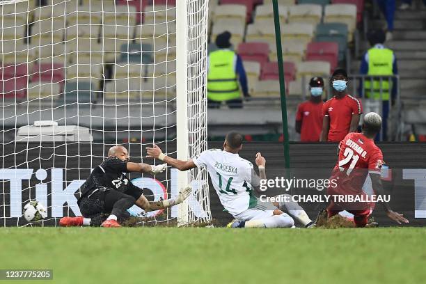 Equatorial Guinea's defender Esteban Obiang shoots and scores past Algeria's goalkeeper Rais M'bolhi during the Group E Africa Cup of Nations 2021...
