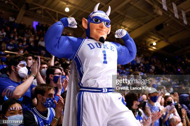 Cameron Crazies and fans of the Duke Blue Devils cheer as the mascot performs prior to their game against the North Carolina State Wolfpack at...