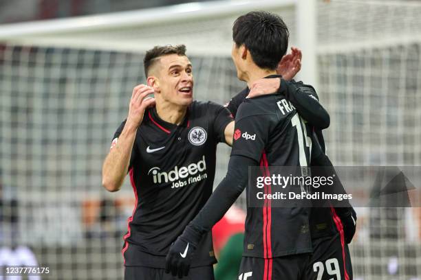 Rafael Borre of Eintracht Frankfurt celebrates after scoring his team's first goal with teammates during the Bundesliga match between FC Augsburg and...