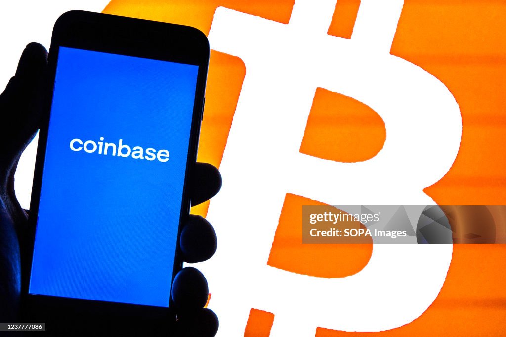 In this photo illustration a Coinbase logo seen displayed on...