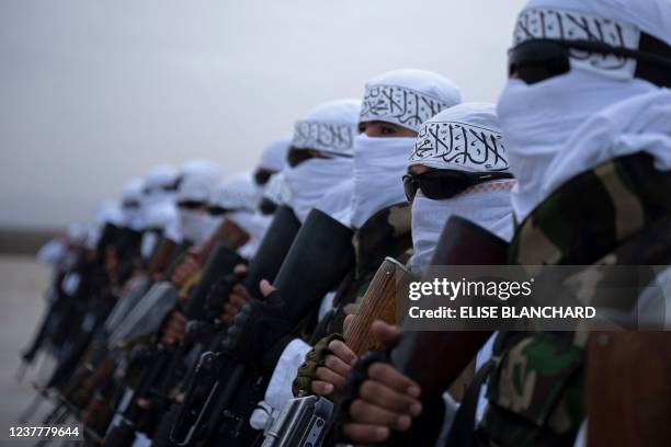 In this photograph taken on January 16 Taliban fighters stand guard during a military street parade in Maymana, capital of Faryab province.