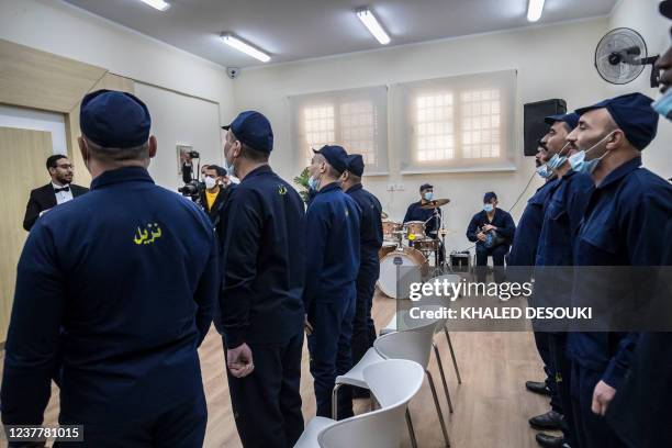 Picture taken on January 16, 2022 shows inmates performing in a band at the Correctional and Rehabilitation Centre in Badr city, 65 kms east of the...