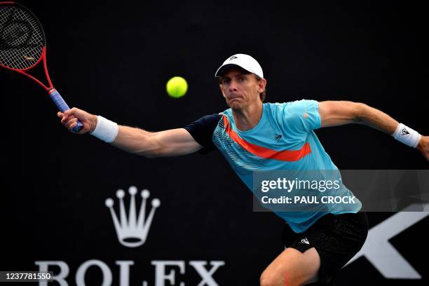 South Africa's Kevin Anderson hits a return against Reilly Opelka of the US during their men's singles match on day one of the Australian Open tennis...