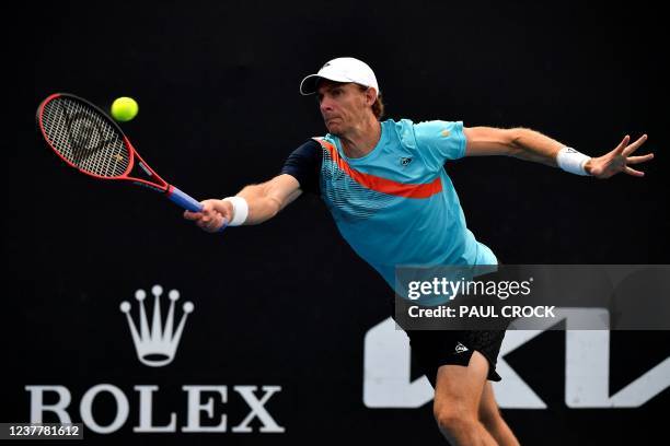 South Africa's Kevin Anderson hits a return against Reilly Opelka of the US during their men's singles match on day one of the Australian Open tennis...