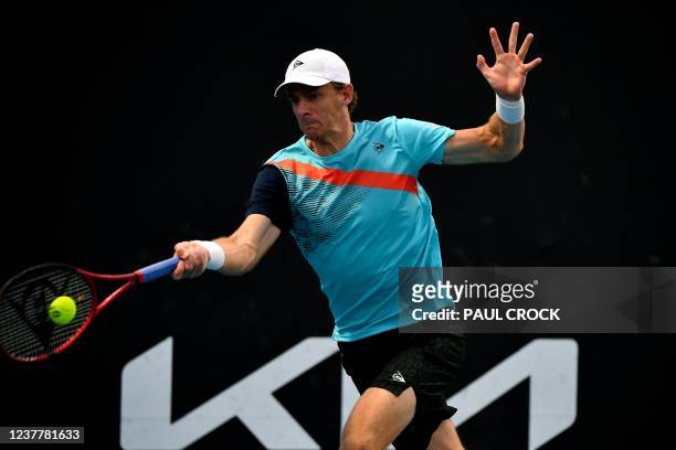 South Africa's Kevin Anderson hits a return against Reilly Opelka of the US during their men's singles match on day one of the Australian Open tennis...
