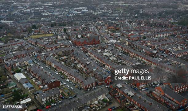 An aerial view shows rows of terraced house, and residential streets in Blackburn, north west England on January 17, 2022. - The man who held four...