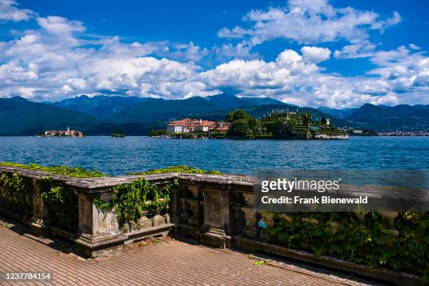 View to the island Isola Bella over Lake Maggiore, a baroque stone railing in the foreground, Isola Superiore and surrounding mountains in the...