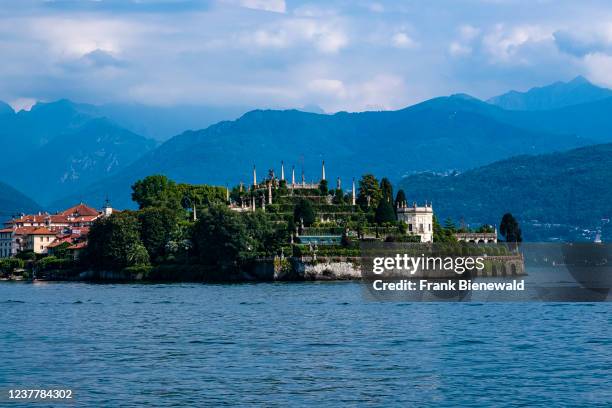 View to the island Isola Bella and its Italianate garden over Lake Maggiore, surrounding mountains in the distance.