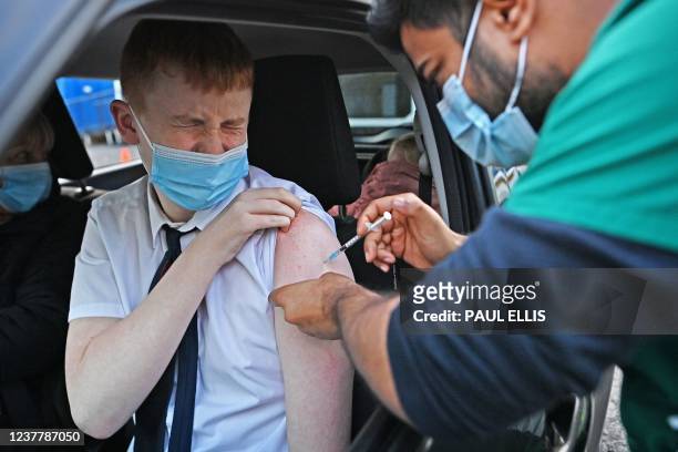 Boy receives a Covid-19 vaccine at a drive-through NHS vaccination centre outside Ewood Park, Blackburn Rovers Football Club in Blackburn in...