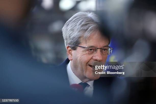 Paolo Gentiloni, European Commissioner for Economy, speaks to members of the media as he arrives for meetings of the Eurogroup and European Union...