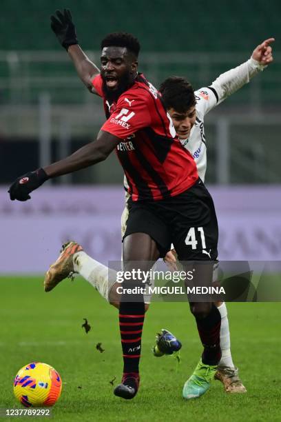 Milan's French midfielder Tiemoue Bakayoko and Spezia's Colombian forward Kevin Agudelo collide during the Italian Serie A football match between AC...