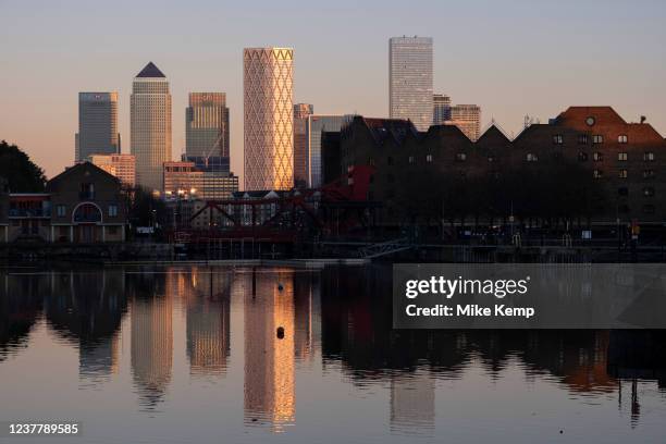 View of the Docklands area, Canary Wharf and financial district across Shadwell Basin and via the Brunel bridge in Wapping on 13th January 2022 in...