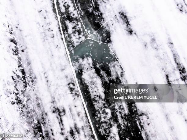 An aerial photo shows cracks on the frozen lake seen on the Northwest Angle ice track at Lake of the Woods between Warroad and Angle Inlet,...