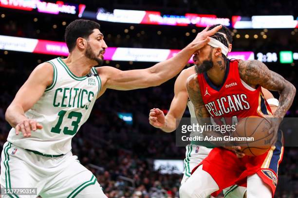 Enes Freedom of the Boston Celtics hits Brandon Ingram of the New Orleans Pelicans in the face while playing defense during a game at TD Garden on...