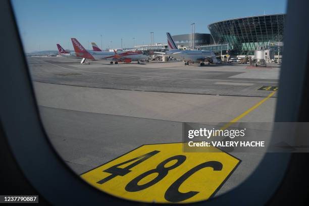 Picture taken on January 15, 2022 from the inside of a plane shows a view of the Nice international airport.