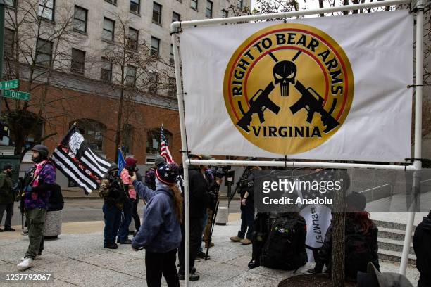 Demonstrators from several gun rights groups come together for a rally and food drive outside of the Virginia State Capitol in Richmond, Virginia on...