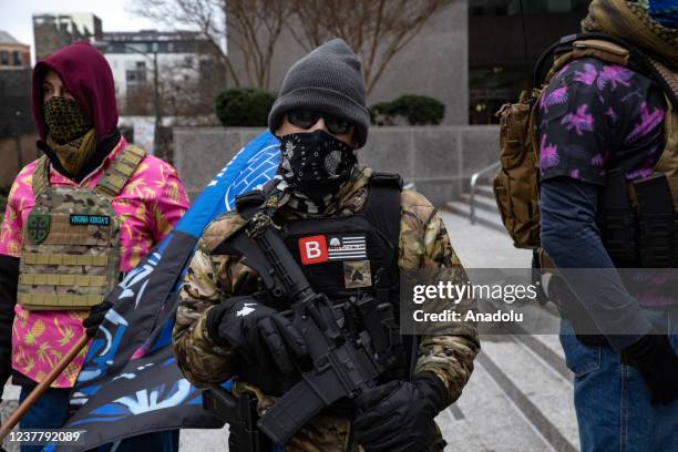 Demonstrators from several gun rights groups come together for a rally and food drive outside of the Virginia State Capitol in Richmond, Virginia on...