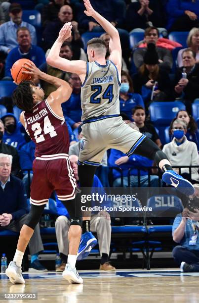 Saint Louis guard Gibson Jimerson leaps to block a shot by Fordham guard Antrell Charlton during a college basketball game between the Fordham Rams...